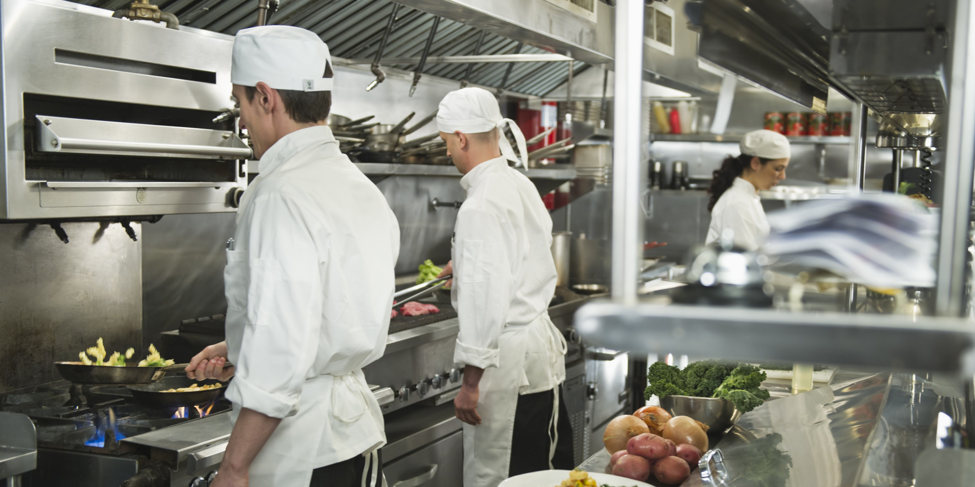 USA, New York State, New York City, Chefs preparing food in kitchen